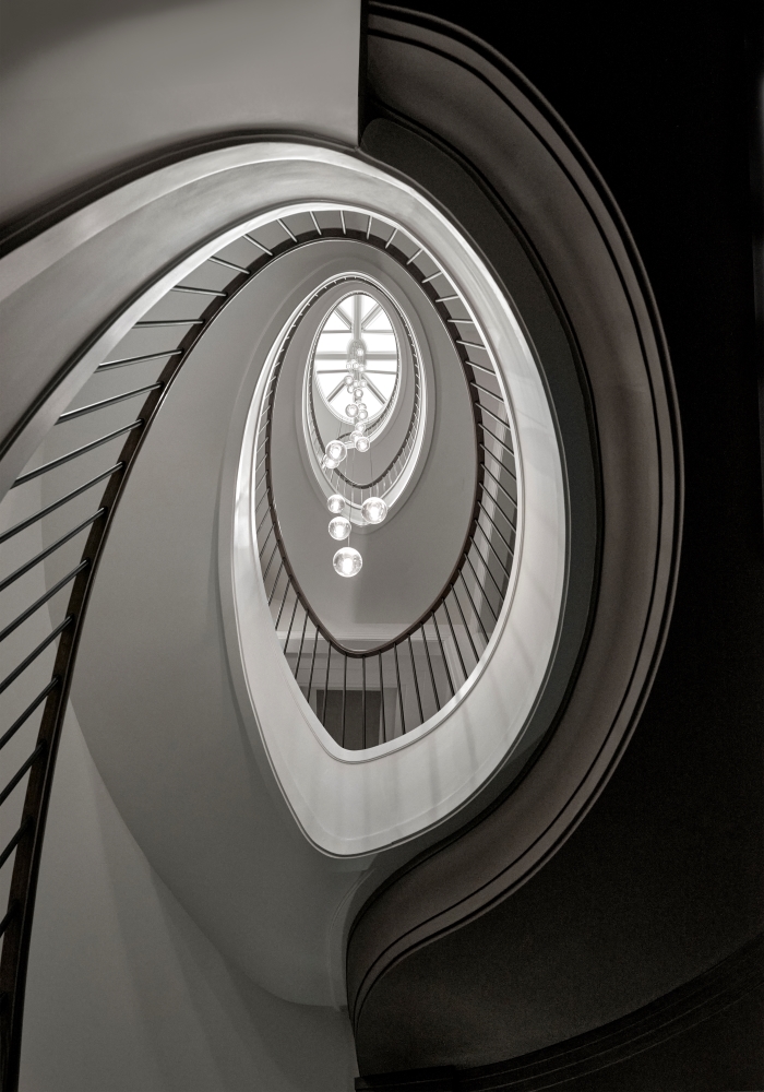 Artistic view looking up at the oval staircase