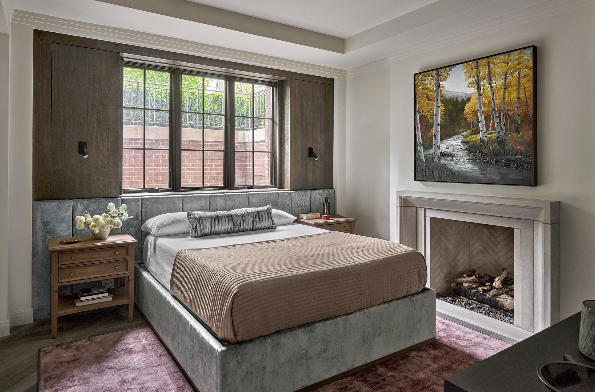 Bedroom including a view of a large window and a fireplace